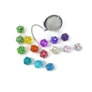 May include: A rainbow-colored set of 12-sided dice, also known as D12s, strung together with a silver chain and a tea infuser. The dice are translucent and have white numbers on them.
