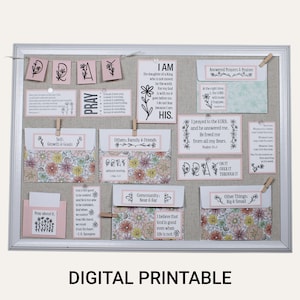 May include: A rectangular white-framed cork board displaying various paper cards and envelopes with floral patterns and religious text. The items are pinned to the board, featuring phrases like I AM, PRAY, and Answered Prayers & Praises.