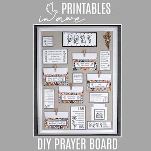 May include: A rectangular white-framed cork board displaying various printed cards and envelopes with floral patterns and religious text. The items are attached with small wooden clips, featuring phrases like PRAY, I AM HIS, and scripture verses.