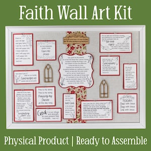 May include: A framed faith wall art kit with various inspirational quotes and religious text. The kit includes several small, rectangular cards with quotes, a central decorative piece, and wooden accents. The color scheme is primarily white, red, and brown.