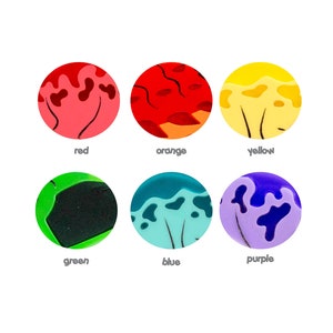 May include: Six round, colorful, resin cabochons with a marbled, abstract design. The colors are red, orange, yellow, green, blue, and purple.