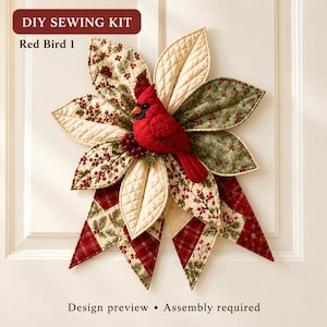May include: A DIY sewing kit titled Red Bird 1 featuring a quilted fabric wall hanging shaped like a flower with pointed petals in cream, green, and red plaid patterns. A plush red cardinal bird is attached to the center.