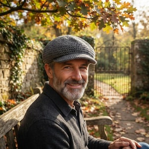 May include: A charcoal gray crocheted flat cap featuring a rounded crown and a short, stiffened brim. The hat is constructed with a dense, uniform stitch pattern, providing a textured appearance and a structured shape that sits firmly on the head.