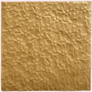 May include: Textured parchment paper with a holly berry design. The paper is a square shape and has a gold color. The words "Textured Parchment Paper" and "Holly Berry" are printed on the image.