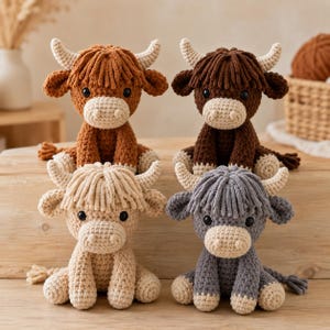 May include: Four crocheted plush highland cow toys in different colors. The top row features a medium brown cow and a dark brown cow. The bottom row features a cream-colored cow and a gray cow. Each toy has cream-colored horns and a snout.