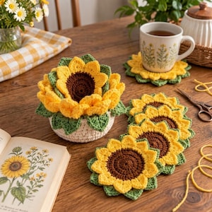 May include: A set of crocheted sunflower coasters and a matching sunflower-shaped bowl. The coasters feature a dark brown center with bright yellow petals and green leaves. The bowl has a cream-colored base with a large, dimensional sunflower top.