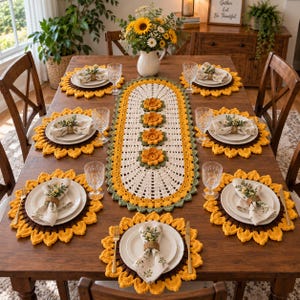 May include: A dining table set featuring an oval crochet table runner with sunflower motifs, matching sunflower-shaped placemats, and white napkins held by wooden rings. Each place setting includes a clear glass, a white plate, and a gold fork and knife.