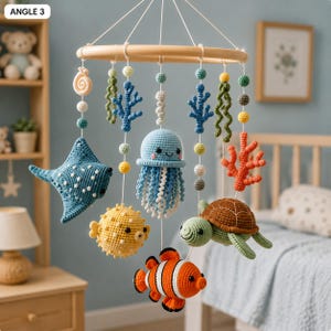 May include: A hanging mobile featuring crocheted sea creatures including a blue stingray, a light blue jellyfish, a yellow pufferfish, a green turtle, and an orange clownfish, suspended from a circular wooden frame with colorful beads and coral.