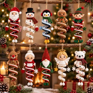 May include: Ten crocheted Christmas ornaments hanging from a wooden branch. The figures include Santa, a snowman, a penguin, a gingerbread person, an elf, a reindeer, Mrs. Claus, a gnome, an angel, and a polar bear, each with a spiral base.