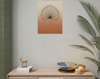 Può includere: Una stampa artistica da parete rettangolare con un disegno a linee nere di una foglia di palma a ventaglio centrato su uno sfondo sfumato che passa dal beige chiaro in alto a un caldo arancione terracotta in basso, con il testo PALM LEAF sotto.