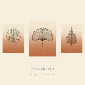 May include: A set of three rectangular prints featuring black line art of a monstera leaf, a ginkgo leaf, and a fern leaf. Each print has a gradient background transitioning from light cream to terracotta. The text reads MONSTERA, GINKGO, FERN, DREIER-SET.