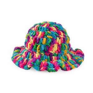 May include: A crochet bucket hat made from thick, plush yarn in a vibrant multicolored pattern featuring bright shades of pink, blue, yellow, green, and purple. The hat has a rounded crown and a wide, wavy brim with a textured, chunky knit.