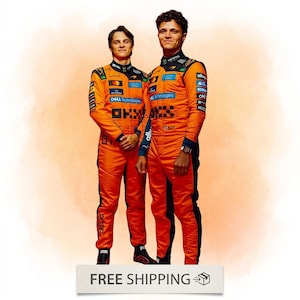 May include: Two individuals wearing bright orange McLaren racing suits with black side panels and various sponsor logos including Dell Technologies, OKX, and Android. The suits feature high collars, long sleeves, and dark accents on the shoulders.