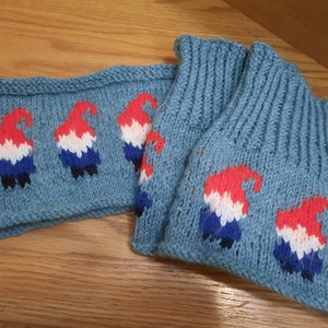 May include: A pair of blue knitted leg warmers with a pattern of red, white, and blue gnomes. The leg warmers are made of a soft, cozy yarn and are perfect for keeping your legs warm in the winter.