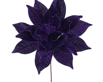 May include: A deep purple artificial poinsettia flower with a velvet-like texture on the petals. The centre of the bloom features small, dark purple glittery accents. The flower is attached to a thin, straight, dark brown stem extending downwards.