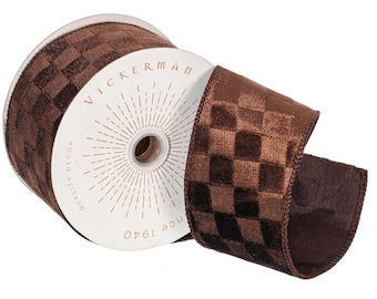 May include: A spool of brown ribbon featuring a checkered pattern with a velvet-like texture. The white cardboard centre is printed with the text VICKERMAN QUALITY DECOR since 1940 and features a sunburst design radiating from the centre hole.