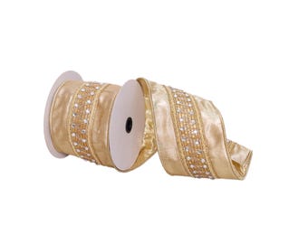 May include: A metallic gold ribbon on a spool featuring a central decorative band with a zigzag pattern and small, clear, reflective circular accents. The ribbon has a smooth, shimmering texture and is partially unrolled to show the design.