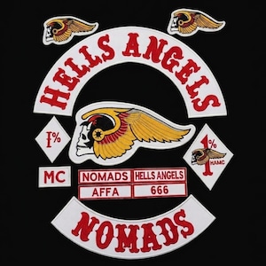 May include: A collection of embroidered patches featuring the text HELLS ANGELS and NOMADS in red on white backgrounds. The set includes a winged skull emblem, two diamond-shaped 1% patches, and rectangular labels with text reading MC, AFFA, and 666.