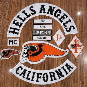 May include: A set of embroidered patches including a large white arched top rocker with black text reading HELLS ANGELS, a bottom rocker reading CALIFORNIA, a central skull and wing emblem, and smaller rectangular patches with text 666, AFFA, HELLS ANGELS, NOMADS, and 1% diamond patches.