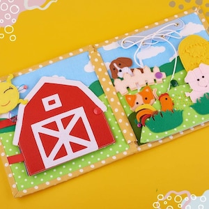 May include: A fabric quiet book featuring a farm theme with a red barn, a yellow sun, and various felt animals including a dog, a pig, and a chicken. The pages are decorated with green polka dot borders and blue sky backgrounds with white clouds.