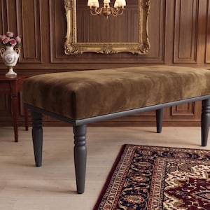 May include: A rectangular bench featuring a plush, dark brown velvet upholstered seat cushion. The base and four legs are constructed from solid wood finished in a matte charcoal grey, with the legs showcasing a classic turned spindle design.