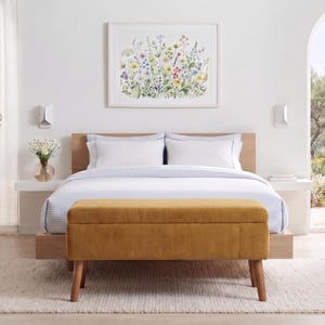 May include: A rectangular mustard yellow corduroy storage bench with four tapered wooden legs positioned at the foot of a bed. The bench features a tufted top surface and a textured ribbed fabric finish, providing a functional seating and storage solution.