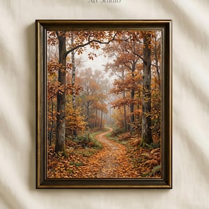 Può includere: Una stampa artistica incorniciata raffigurante un sentiero nel bosco coperto di foglie autunnali arancioni e marroni, circondato da alberi alti con fogliame dorato. Il testo Vintage Paper Art Studio è stampato in nero sopra la cornice marrone scuro.