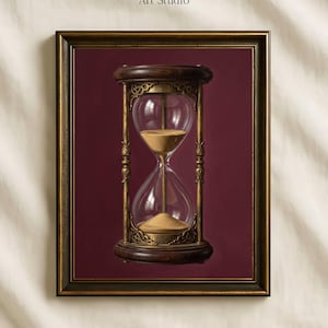 May include: A framed wall art print featuring an hourglass with dark wood ends and ornate gold metal supports, filled with golden sand, set against a deep burgundy background. The text Vintage Paper Art Studio appears above the frame.