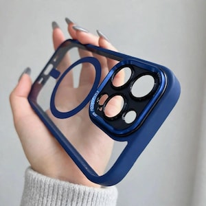 May include: A navy blue phone case with a clear back panel, featuring a dark blue circular magnetic ring in the center. The camera module area is raised, black, and includes the text FOCUS PIXELS printed around the lens cutouts.