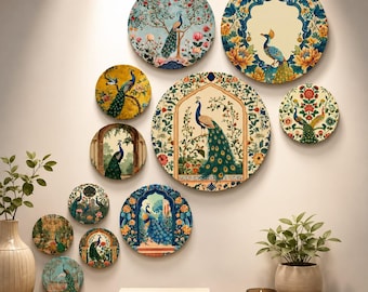 May include: A collection of eleven circular wall art pieces featuring intricate peacock illustrations and floral motifs in vibrant shades of blue, gold, green, and red, arranged in a cluster on a wall above a wooden surface with two potted plants.