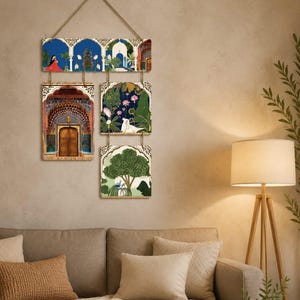May include: A wall hanging consisting of four rectangular panels suspended by twine. The top panel features an architectural archway with a figure in red. Below are three square panels depicting a wooden door, lotus flowers, and a green tree.