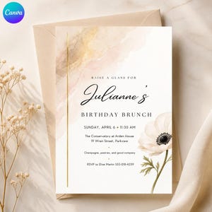 May include: A rectangular birthday brunch invitation card featuring a watercolour wash in shades of beige and gold, a vertical gold line, and a white anemone flower. The text reads: Raise a glass for Julianne's Birthday Brunch, Sunday, April 6, 11:30 AM.