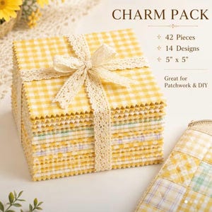 May include: A stack of 42 square fabric pieces in 14 designs, tied with a cream lace ribbon. The fabric features yellow and white gingham patterns. Text on the image reads: CHARM PACK, 42 Pieces, 14 Designs, 5" x 5". A quilted pouch is visible.