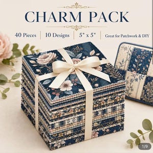 May include: A stack of 40 fabric squares labeled CHARM PACK, 10 Designs, 5" x 5". The fabric features navy blue backgrounds with floral and botanical patterns in pink, cream, and blue. The stack is tied with a cream ribbon and has pinked edges.