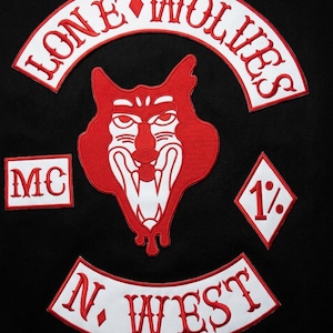 May include: A set of embroidered patches on a black background featuring a central red and white wolf head, a curved top patch reading LONE WOLVES, a bottom curved patch reading N. WEST, a rectangular MC patch, and a diamond-shaped 1% patch.