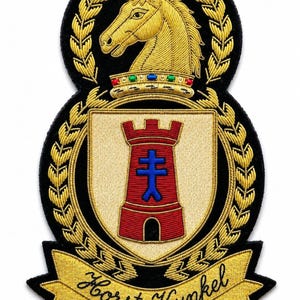 May include: An embroidered patch featuring a gold horse head above a crown and a shield with a red tower and blue cross. The design is framed by gold laurel leaves on a black background, with a gold banner at the bottom reading Horst Kunkel.