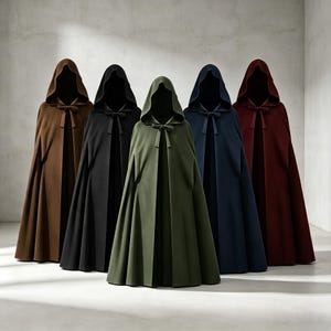 May include: Five floor-length hooded cloaks arranged in a row, featuring colors of brown, black, olive green, navy blue, and deep red. Each cloak has a structured hood, a tie closure at the neck, and a full, pleated skirt that drapes to the floor.