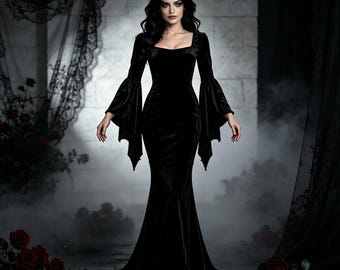 May include: A floor-length black velvet dress featuring a square neckline and long, flared bell sleeves with pointed, jagged hems. The garment has a fitted bodice that transitions into a flowing, floor-sweeping skirt, creating a sleek silhouette.