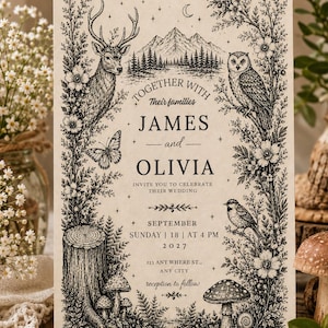 Peut inclure: Une carte d'invitation de mariage rectangulaire sur papier crème avec des illustrations à l'encre noire représentant un cerf, un hibou, un papillon, des montagnes, des arbres et des champignons. Le texte indique : Together with their families James and Olivia invite you to celebrate their wedding September Sunday 18 at 4 PM 2027 123 Any Where St., Any City reception to follow.