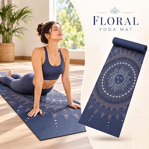 May include: A navy blue yoga mat featuring a white sun graphic surrounded by intricate floral and mandala patterns. The text "FLORAL YOGA MAT" is printed in dark blue at the top. The mat is shown both laid flat and partially rolled up.