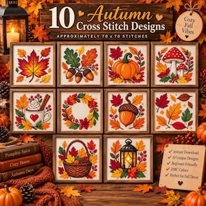 May include: A collection of 10 framed cross stitch designs featuring autumn themes like pumpkins, acorns, mushrooms, and fall leaves. The display includes a sign labeled 10 Autumn Cross Stitch Designs and a list of features including instant download.