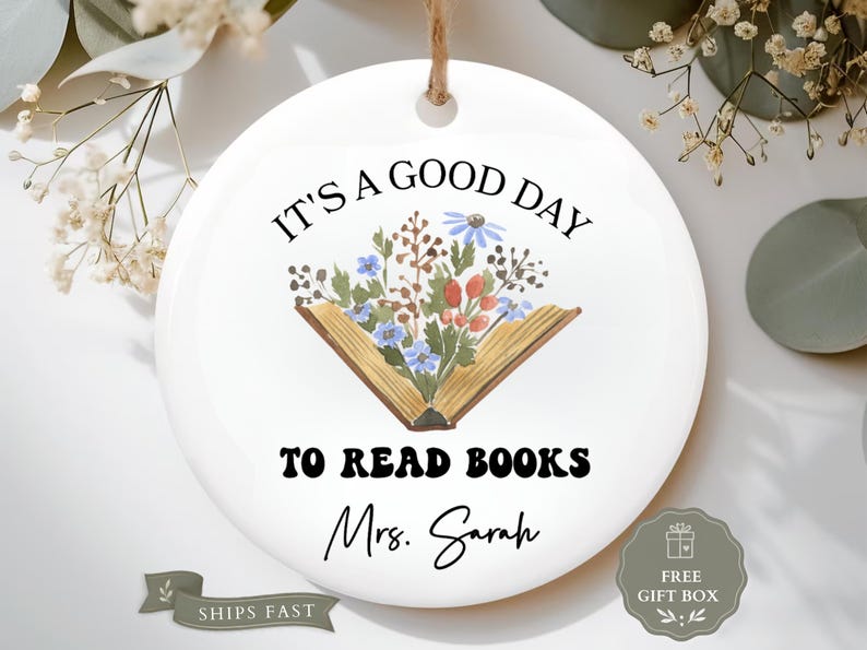 Round ornament with "It's a good day to read books Mrs. Sarah" and floral design.
