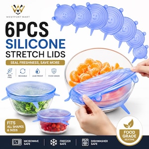May include: A set of six blue silicone stretch lids featuring a smiley face design. The lids are shown covering glass bowls filled with fresh produce, including leafy greens, red berries, and orange slices, demonstrating their flexible fit.