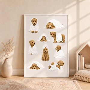 May include: A framed wall art print featuring a collection of illustrations of golden-brown puppies wrapped in white towels. The puppies are depicted in various poses, including sitting, lying down, and peeking out from under the soft white fabric.