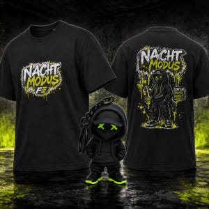 May include: A black t-shirt featuring the text NACHT MODUS in white and yellow on the front and back, with a graphic of a hooded figure holding a spray can on the back. A small black figurine with a hood and neon green X-shaped eyes is included.