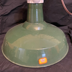 May include: Green enamel industrial pendant light with a white porcelain socket and a Benjamin Electric label.