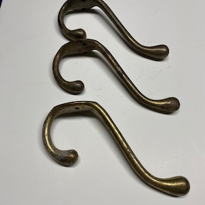 Antique cast brass rusty coat hooks