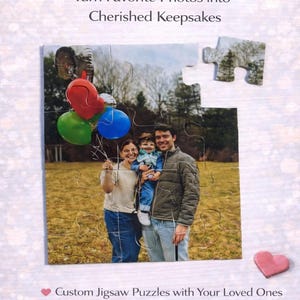 May include: A custom jigsaw puzzle featuring a family portrait with a field background and colorful balloons. The text reads "Capture the Good Times" and "Turn Favorite Photos into Cherished Keepsakes."