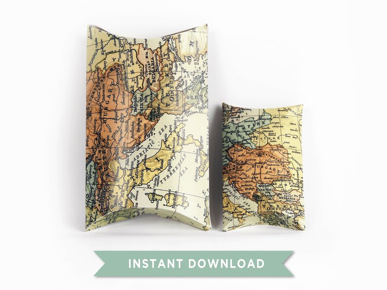 May include: Two vintage map-patterned pillow boxes. The larger box is taller and wider than the smaller box. Both boxes are made of cardboard and have a cream background with a vintage map design in shades of brown, orange, and yellow.