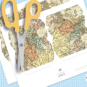 May include: Printable DIY paper craft project featuring a vintage world map design. The template includes a cut-out shape for a box, with instructions to "Cut all around the lines. Score along all fold lines. Apply double sided tape to the tabs and assemble the box."
